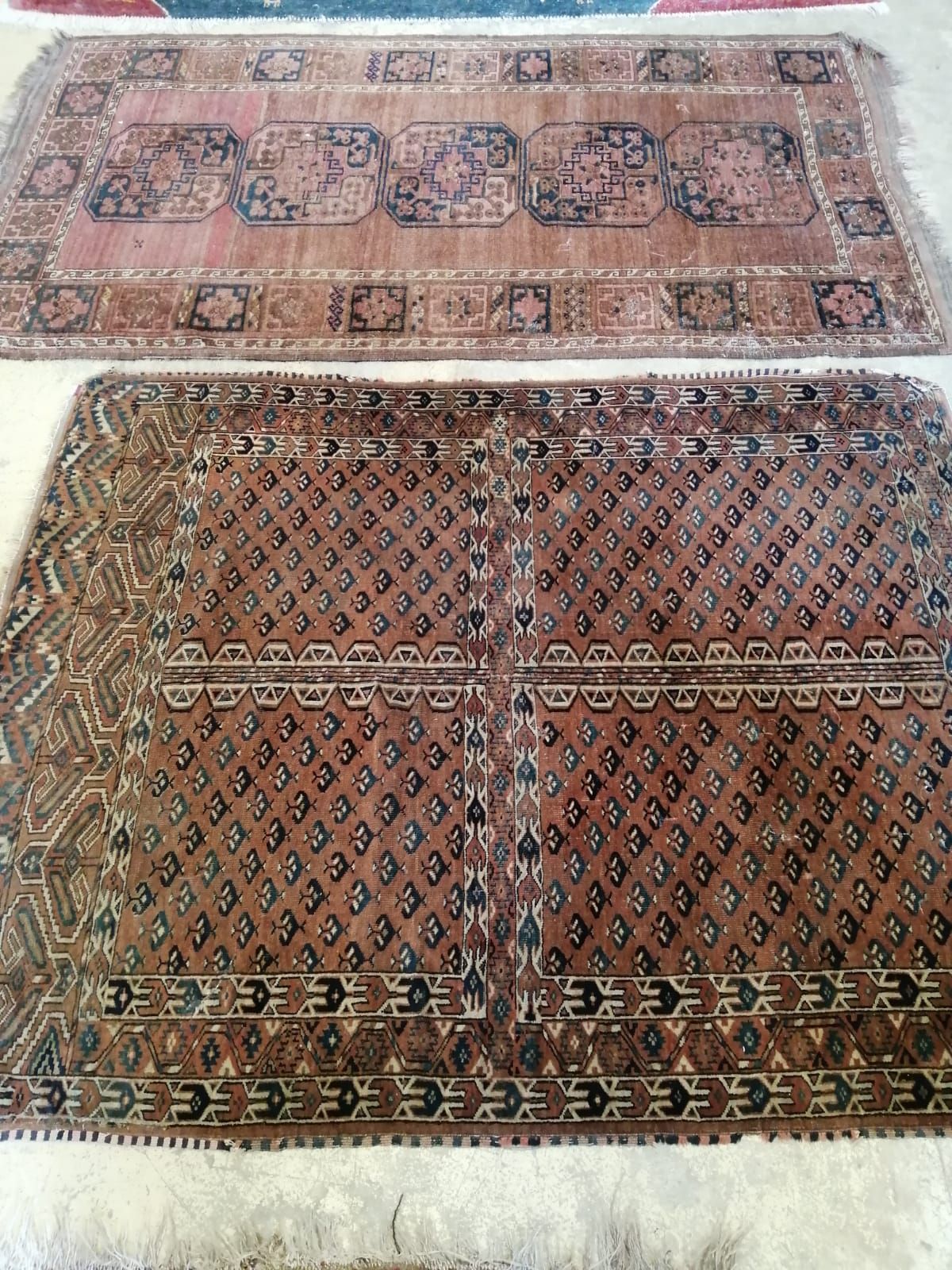 An Afghan red ground rug, 190 x 107cm together with a Turkoman red ground rug, 158 x 122cm